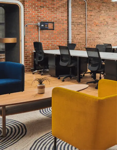  Comfortable looking colorful lounge chairs in front of coworking area.