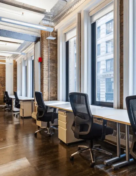 Rows of chairs and desks facing large picture windows.