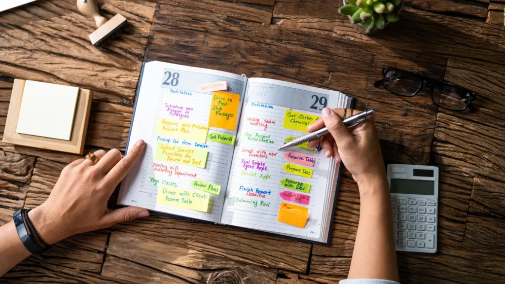 Open planner filled with colorful sticky notes and handwritten tasks