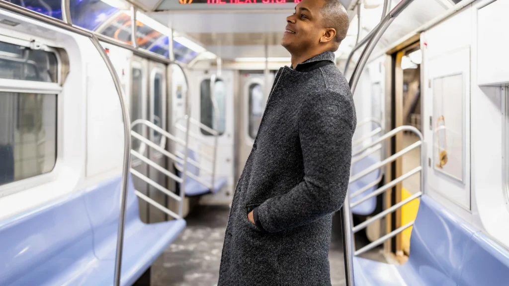 Person standing inside a subway car.