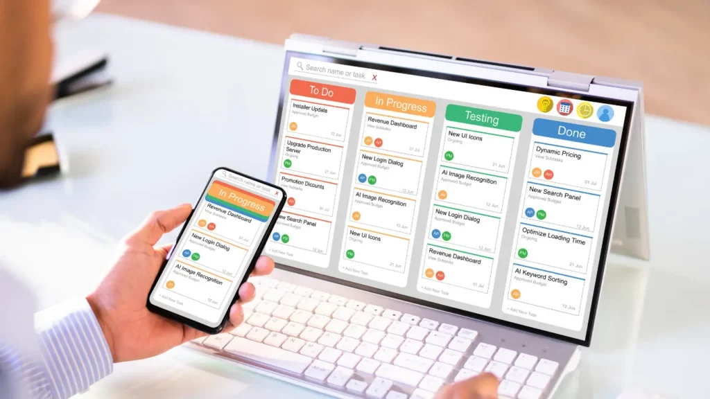 Project management board displayed on a laptop and smartphone screens